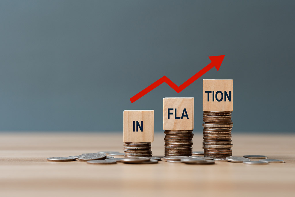 INFLATION word on a wooden cube on coins in idea for FED consider interest rate hike, world economics, and inflation control, AU dollar inflation